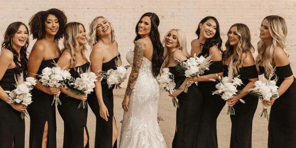 bride smiling and laughing with her bridesmaids 