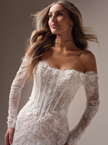An ethereal wedding dress with beaded lace details and a basque waist featuring exposed boning