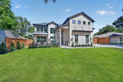 Modern two-story house with large lawn.