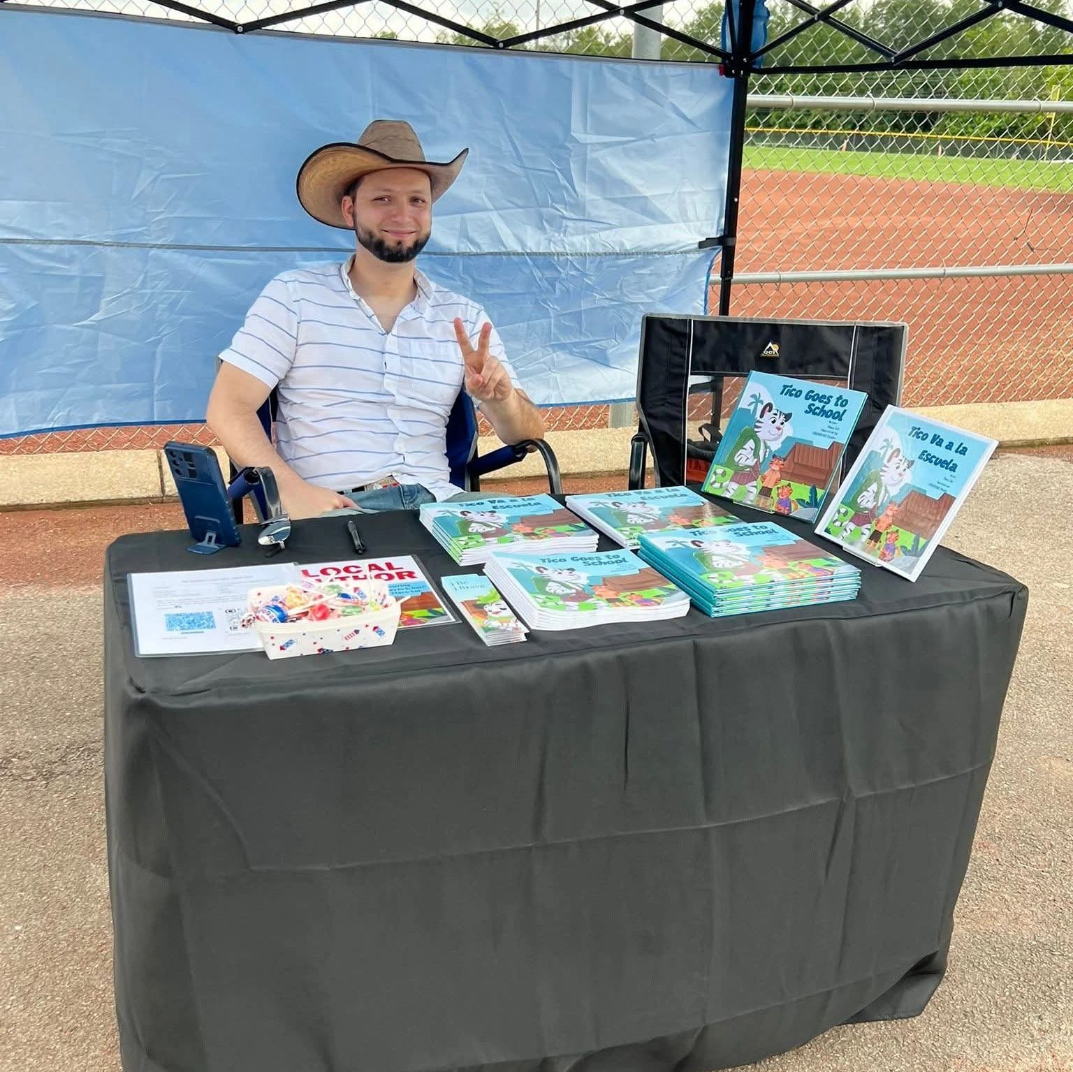 Author Flaco Sol at a book signing event in Tennessee - showcasing some copies of Tico Goes to Schoo
