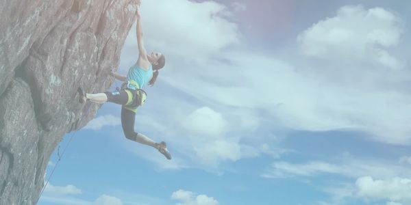 a mountain climber scaling the side of a rock