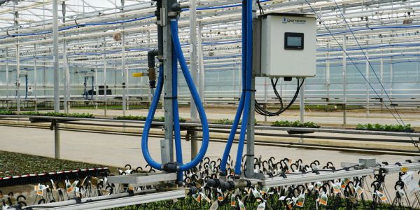 An advanced greenhouse with plants and irrigation control system.