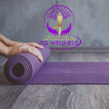 Image of hands rolling out purple yoga mat on grey hardwood flood & worship to wellness logo.