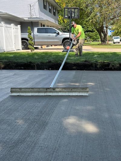 Man finishing new concrete driveway