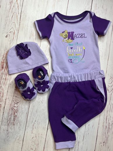 Bodysuit with jogger pants, hat, and crib shoes.