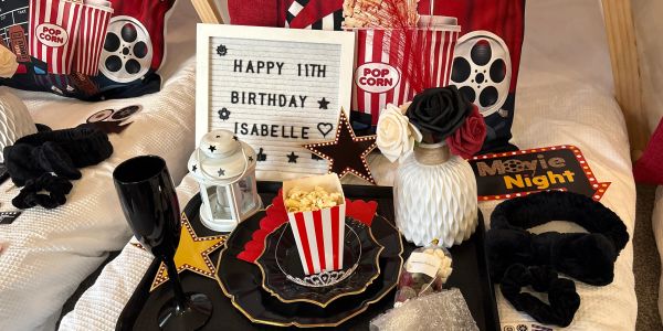 Birthday movie night setup with popcorn and decorations.