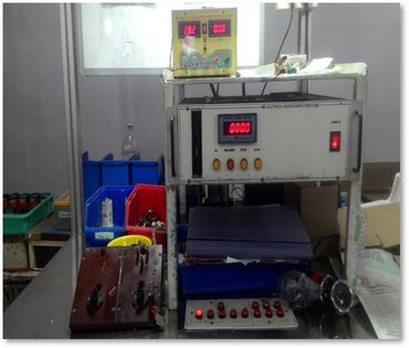Electrical testing equipment setup with meters and control panel.