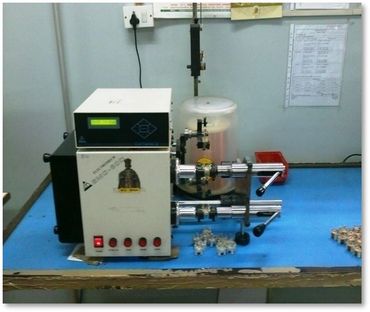 Scientific instrument setup on a blue table with various components and controls.