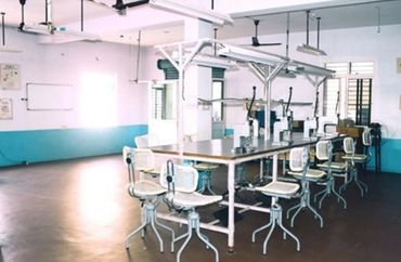 Empty laboratory room with stools and workstations.