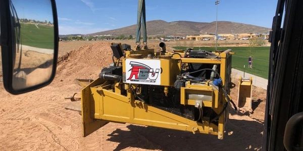 A construction machine that is working with a Team Red Logo on it