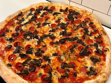 whole round mushroom and pepperoni pizza