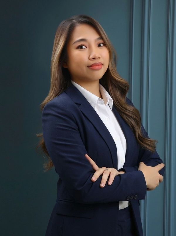 Confident woman in navy suit crossing her arms.