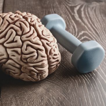 A brain next to a dumbbell 
