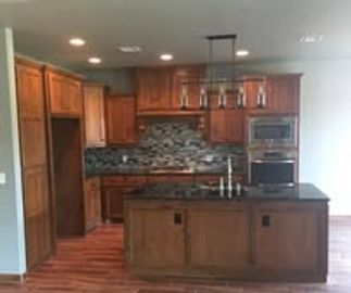 Modern kitchen with wood cabinets and a central island.