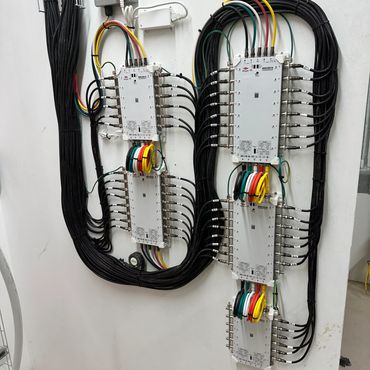 A neatly organized setup of multiple electronic control units with connected cables.