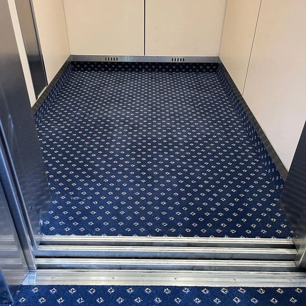 blue patterned carpet in commercial lift