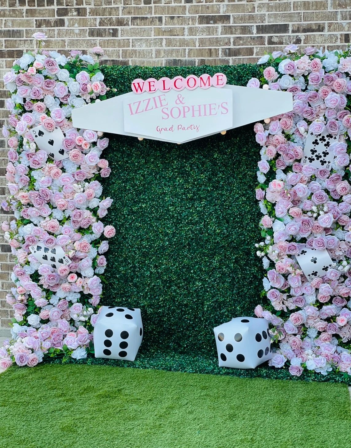 Flowerwall backdrop with green and pink roses with dice