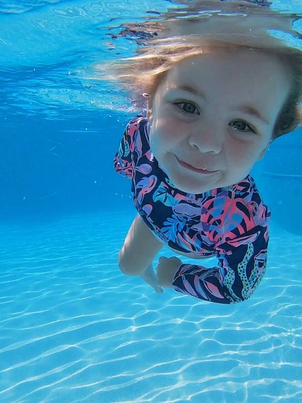 Toddler swims underwater