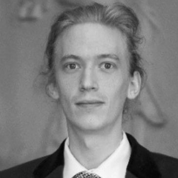 Black and white portrait of a young man in formal attire.