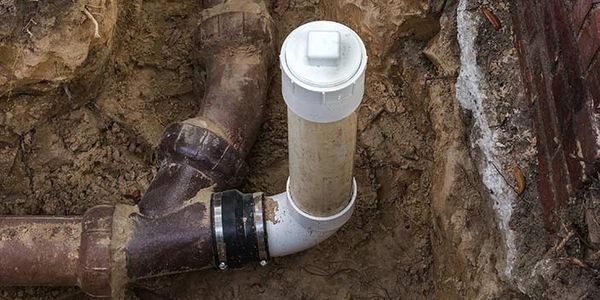 A technician performs professional sewer line cleaning using high-pressure hydro-jetting equipment.