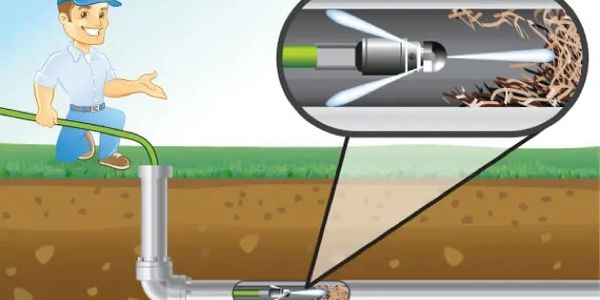 A heavy-duty sewer cleaner machine stands ready to clear a residential blockage.