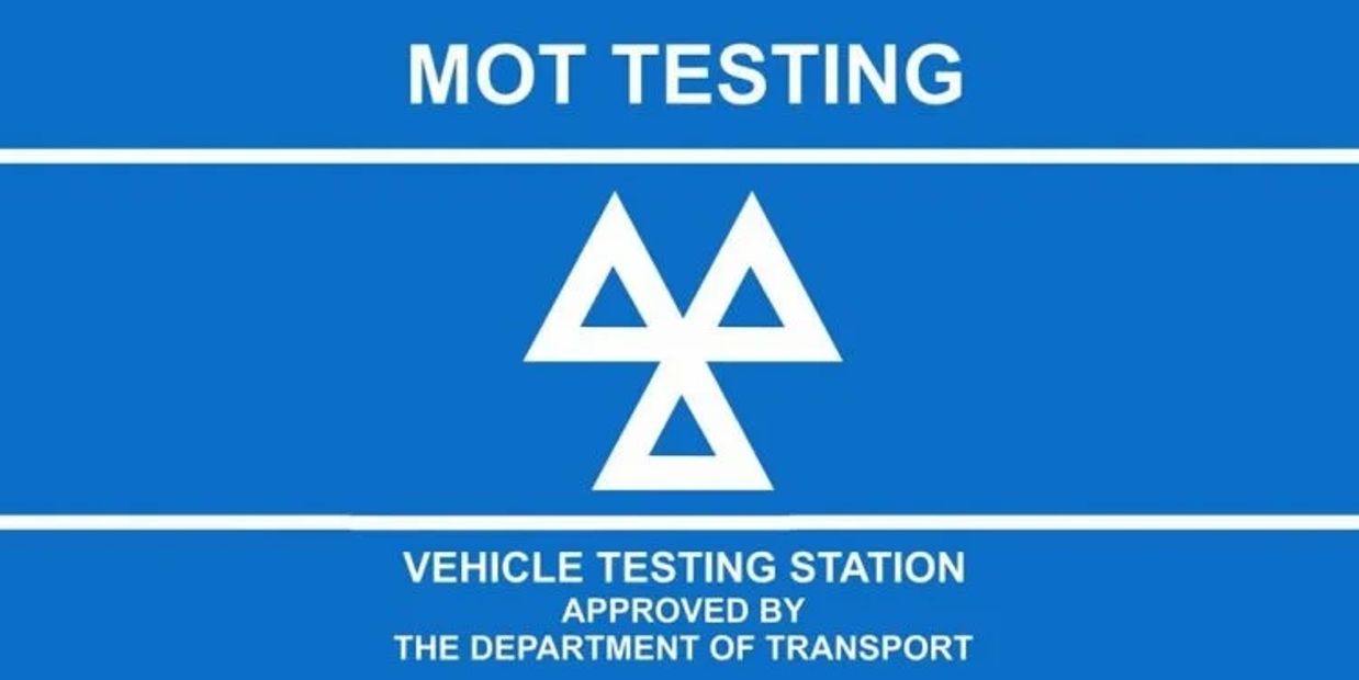 Blue MOT testing sign for vehicle inspection.