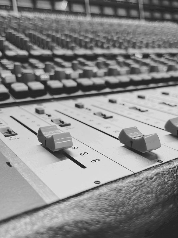 Close-up of Solid State Logic 4000E Recording console sliders in black and white.
