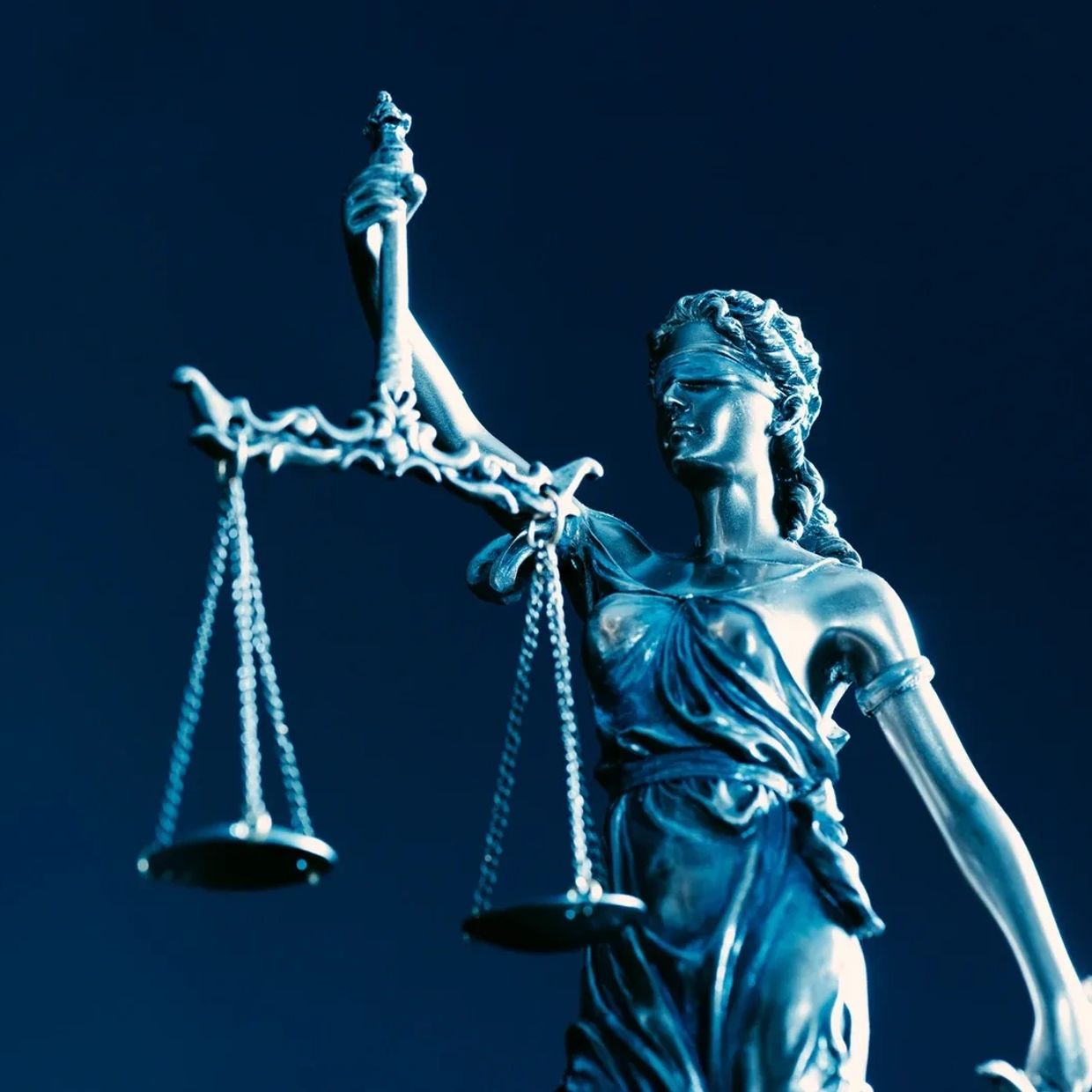 Blue blackground with lady justice holding a scale.
