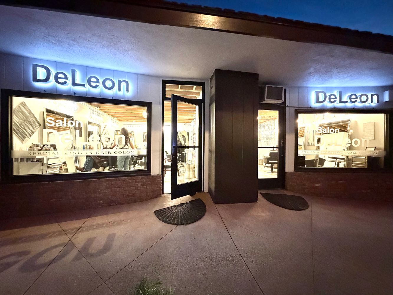 Stack of books next to pencils in a holder and a camera.