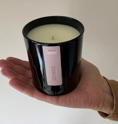 candle on a hand with instructions how to care for it