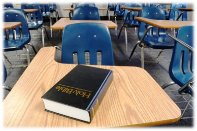 Holy Bible on a classroom desk.