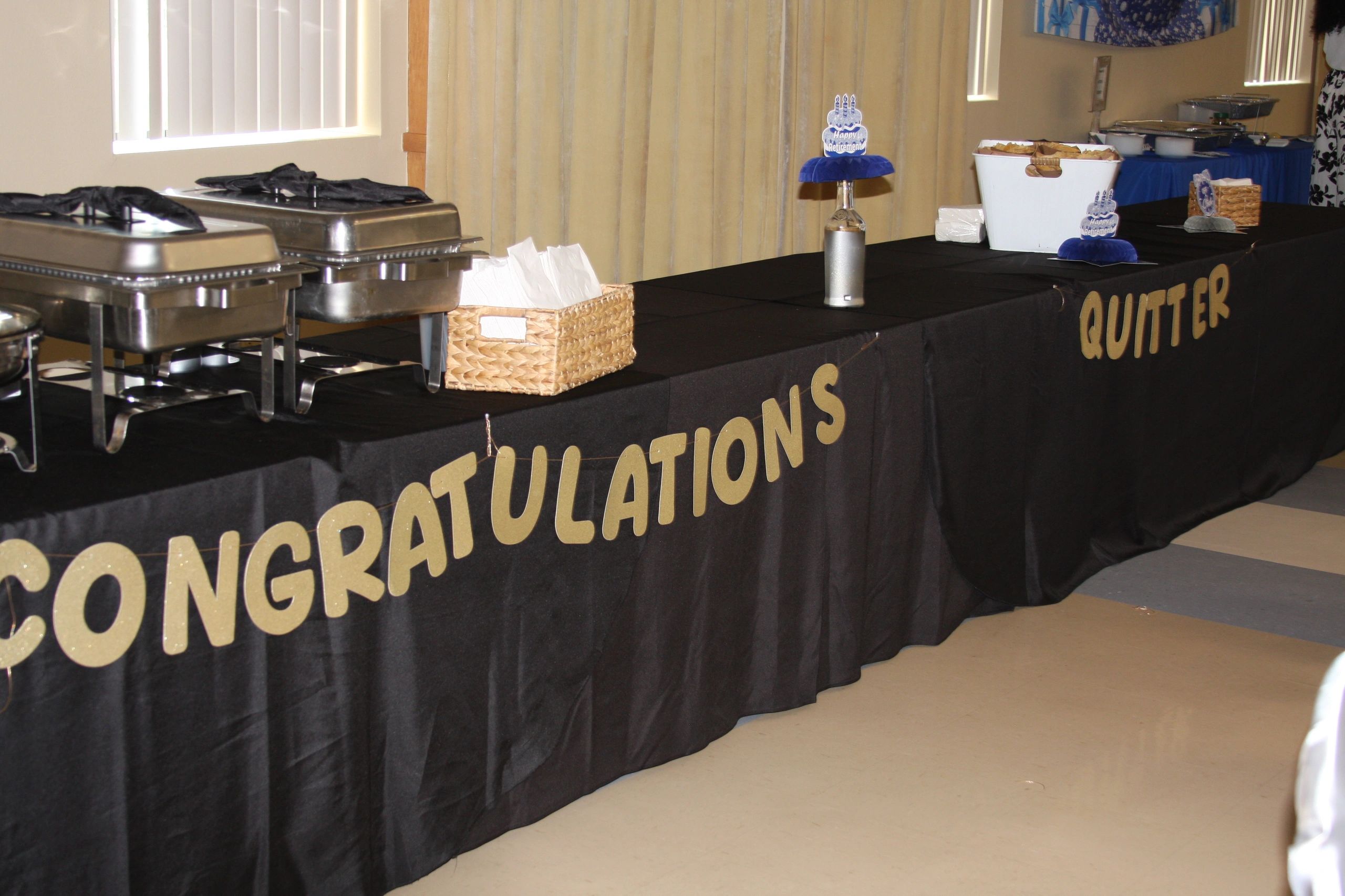 Retirement celebration buffet setup with "Congratulations Quitter" banner.