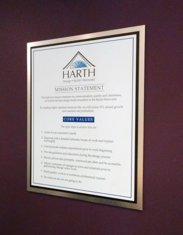 Framed mission statement and core values on a wall.