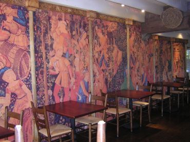 Artistic wall murals in a restaurant seating area.