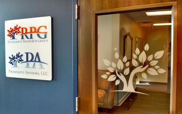 Office entrance with company logos and glass door tree decal.