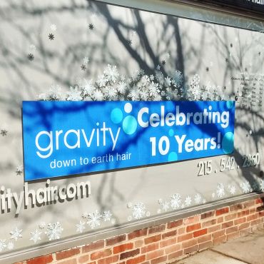 Hair salon celebrates 10 years with a winter-themed window display.
