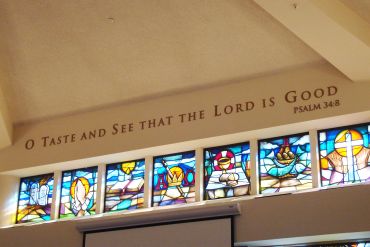 Stained glass windows with a Psalm quote above.