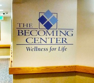 Sign for The Becoming Center promoting wellness.
