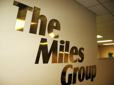 Wall sign reading 'The Miles Group'.