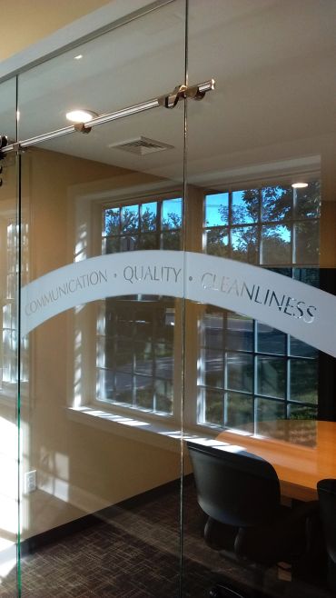 Glass door with words communication, quality, and cleanliness.