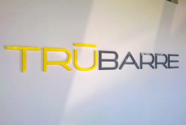 TRUBARRE sign on a wall in yellow and black.