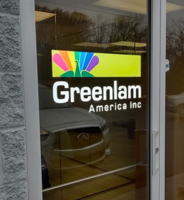 Greenlam America Inc logo on glass door.