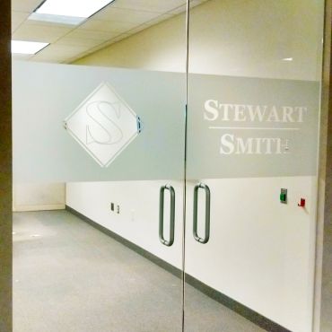 Glass doors with Stewart Smith logo and name.
