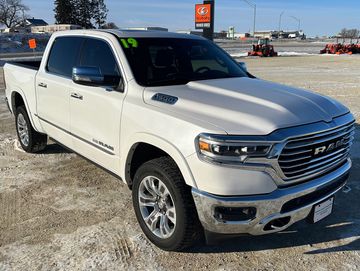 White RAM 1500 pickup truck parked on a snowy lot.