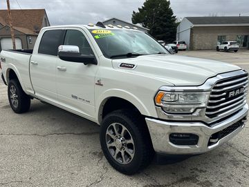 White 2019 RAM 2500 pickup truck parked outdoors.