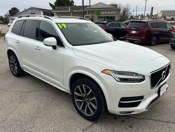 White 2019 Volvo XC90 SUV parked outside a building.