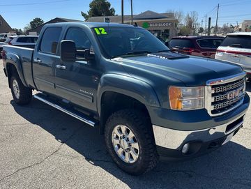 Blue GMC Sierra 2500HD pickup truck parked outdoors.