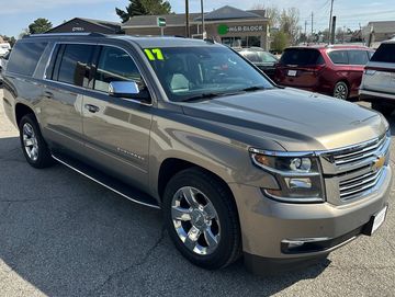 2017 Chevrolet Suburban SUV in metallic beige parked outdoors.