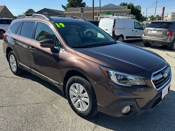 Brown Subaru Outback parked outdoors.