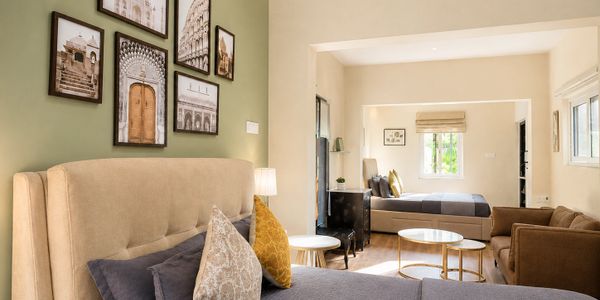 Cozy bedroom with neutral tones and framed wall art.